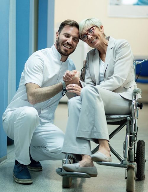 happy-mature-woman-wheelchair-holding-hands-with-her-doctor-hospital-hallway_637285-705 happy-mature-woman-wheelchair-holding-hands-with-her-doctor-hospital-hallway_637285-705